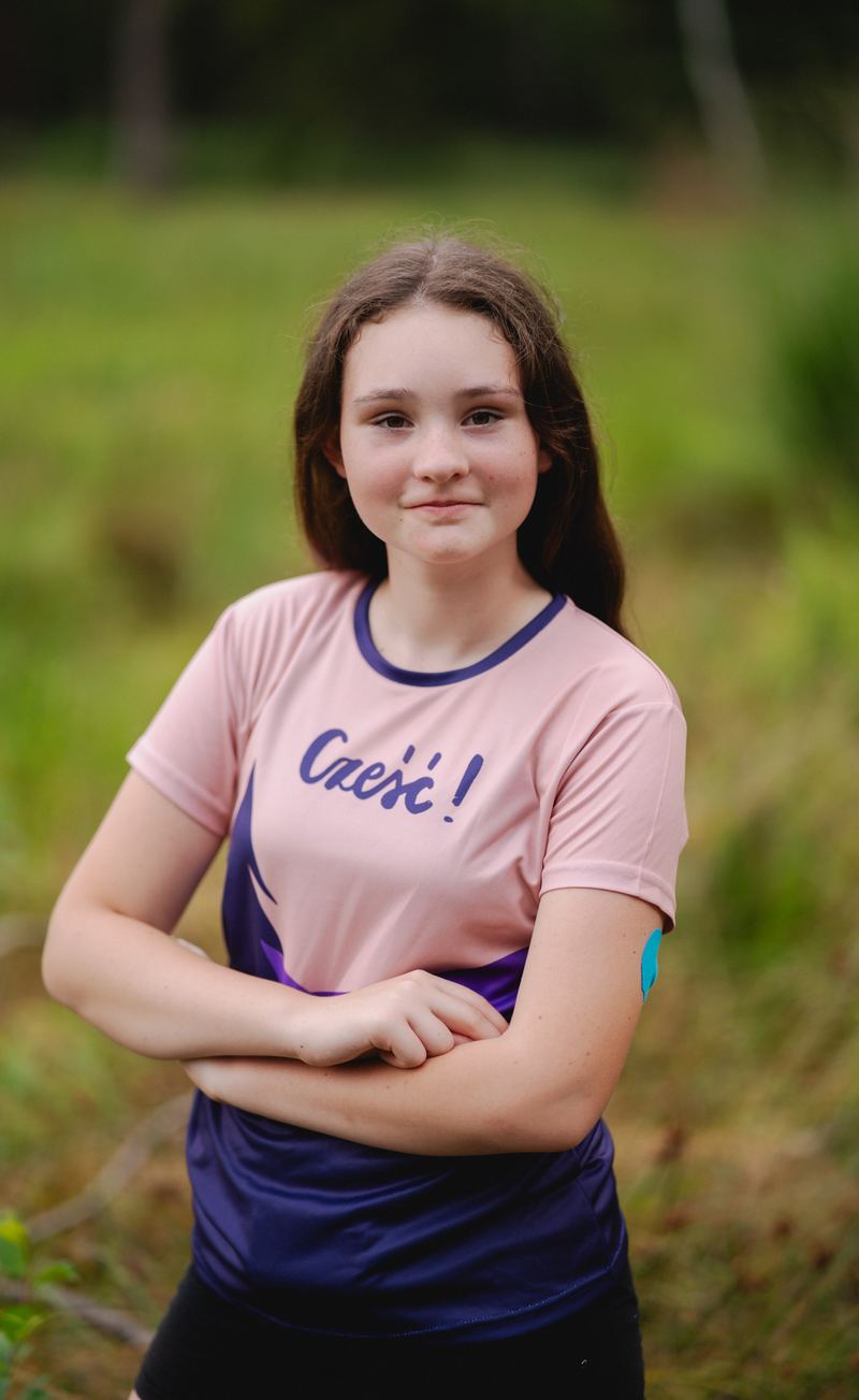 Girl in a pink and navy printed sports shirt